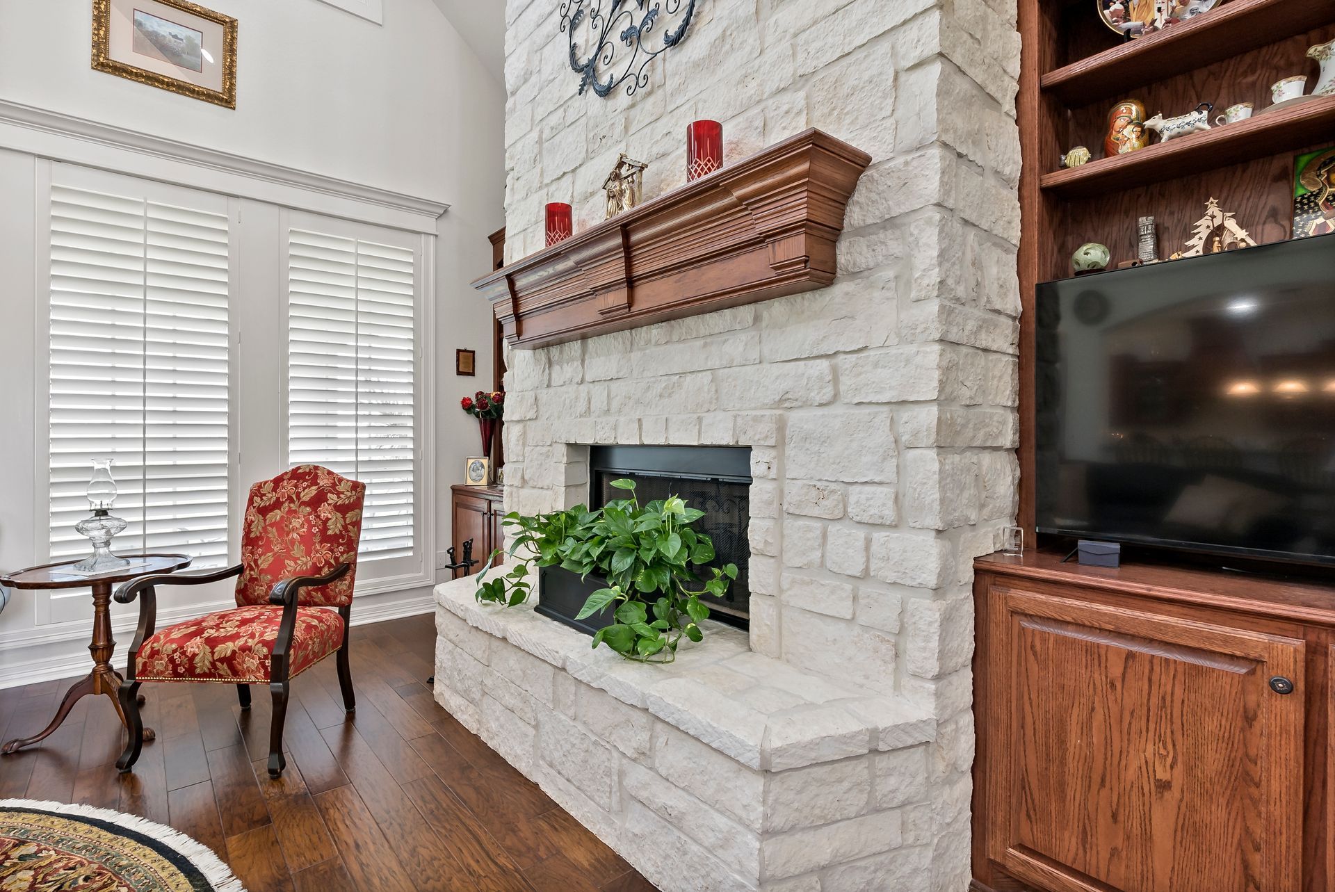 A living room with a fireplace and a flat screen tv.