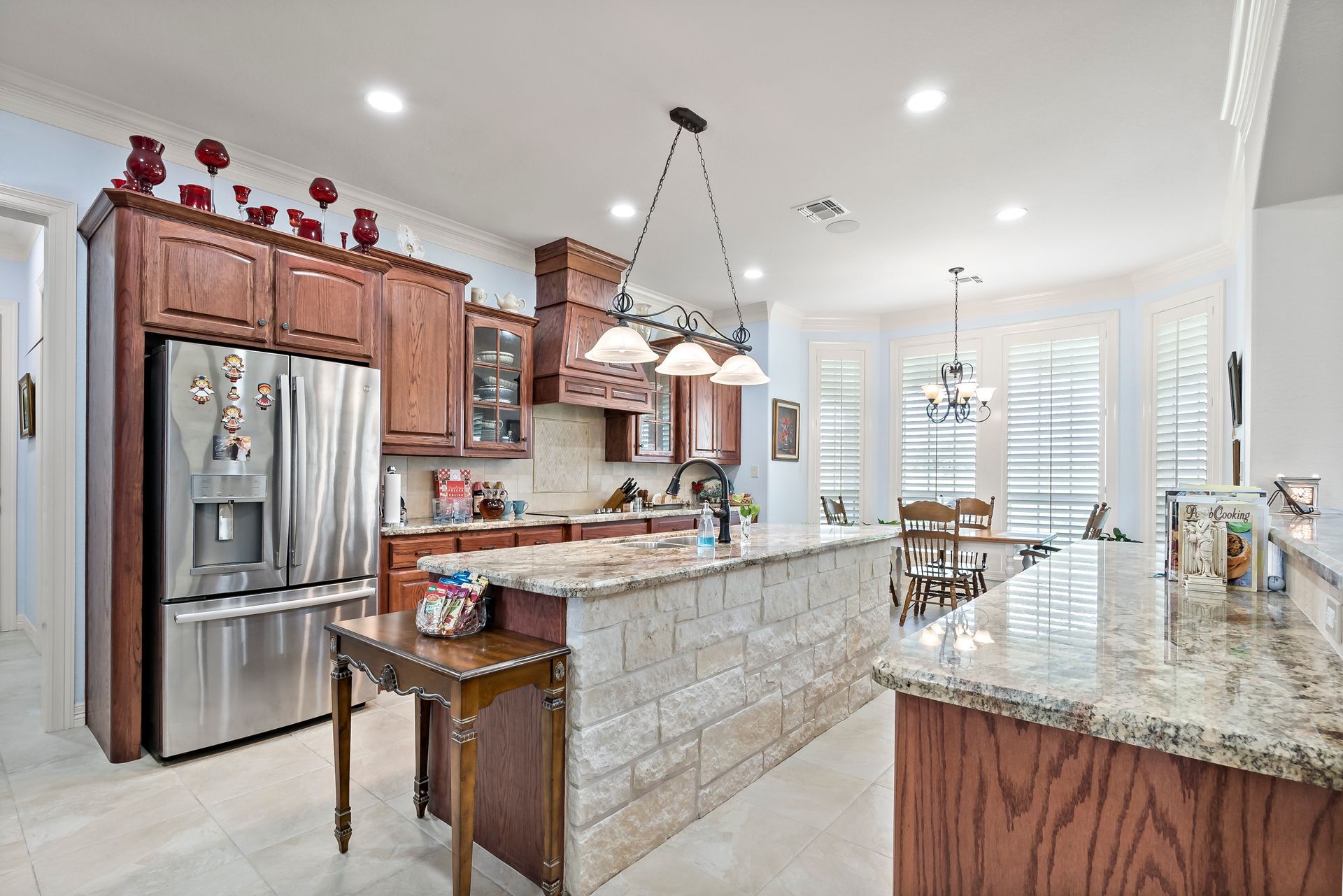 A kitchen with stainless steel appliances and granite counter tops.