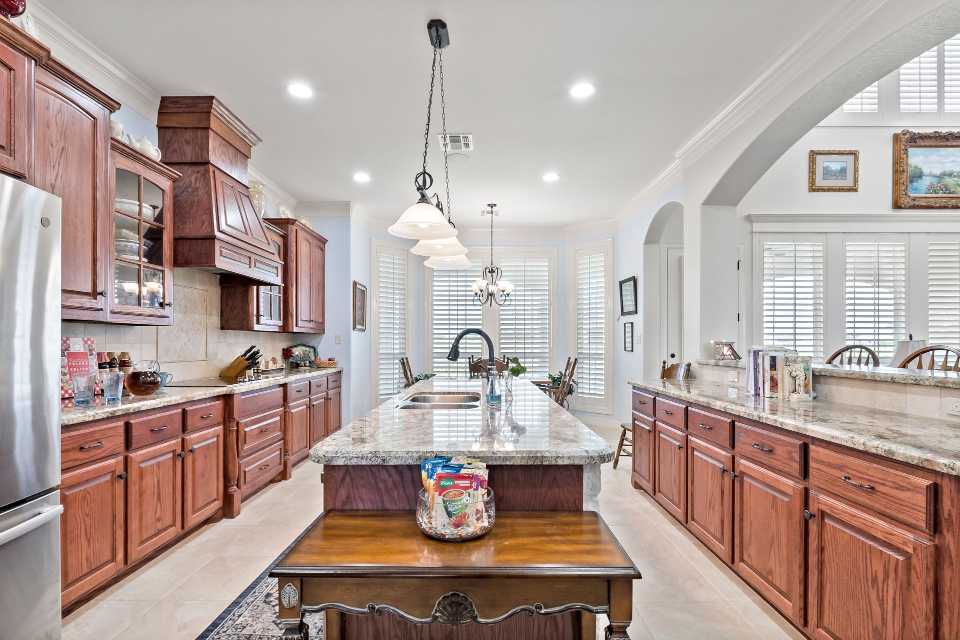 A kitchen with wooden cabinets and granite counter tops