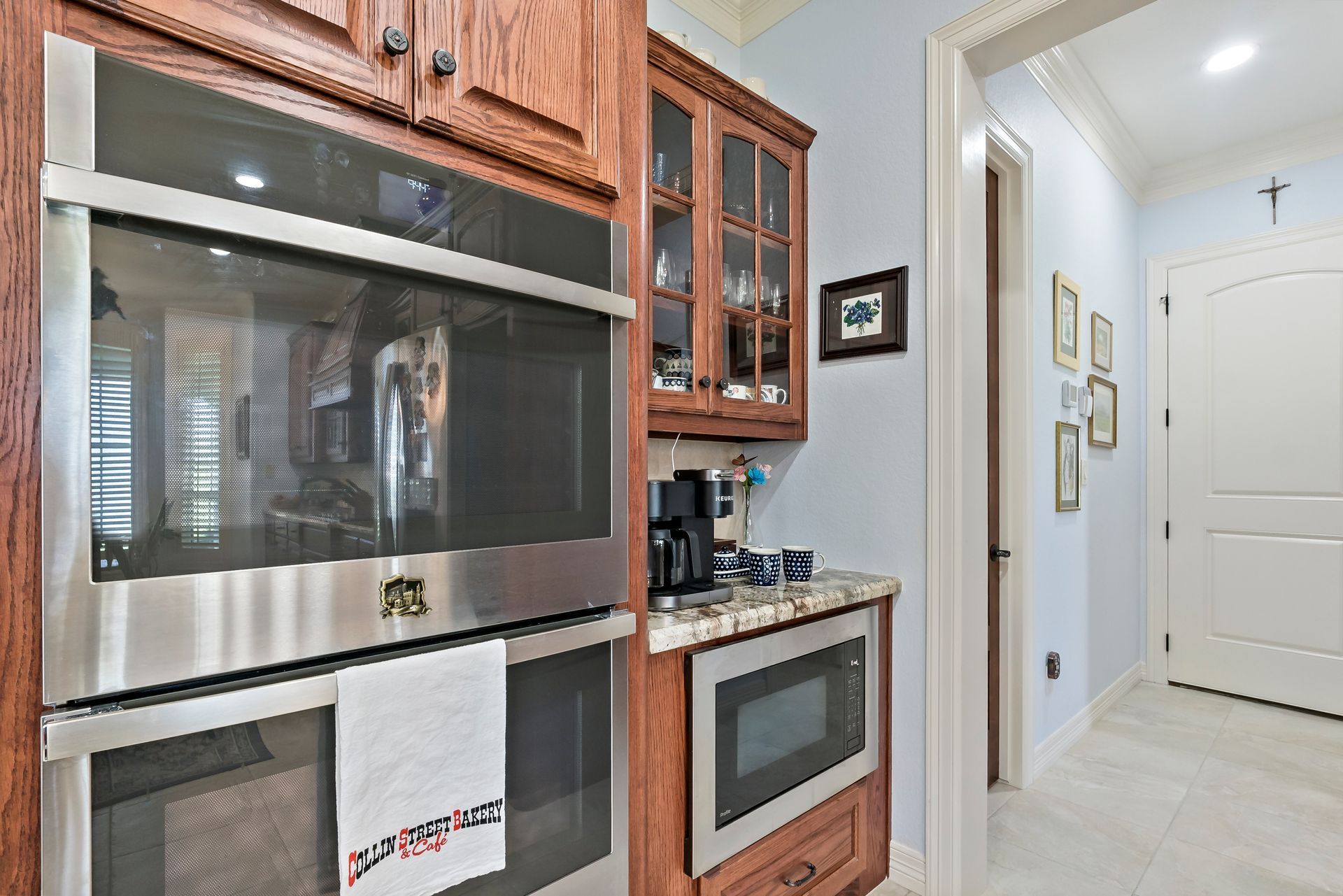 A kitchen with stainless steel appliances and wooden cabinets.