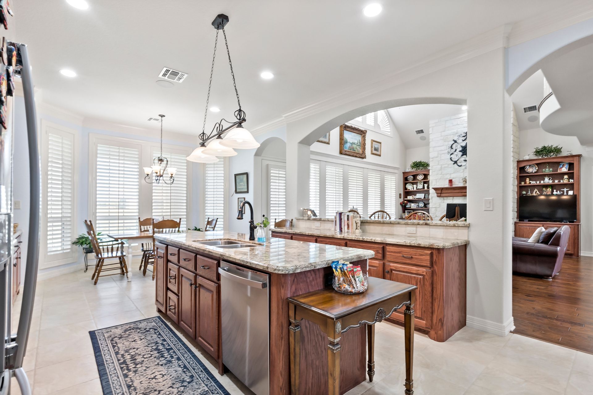 A kitchen with a large island and stainless steel appliances.