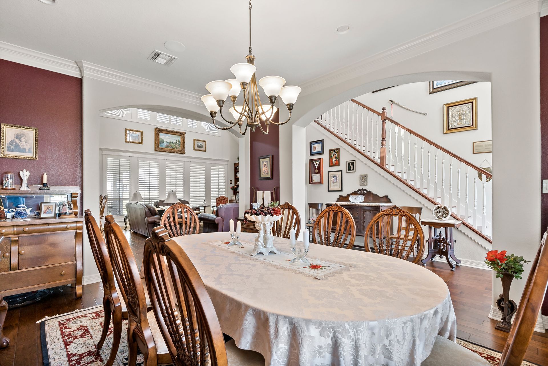 A dining room with a table and chairs and a chandelier