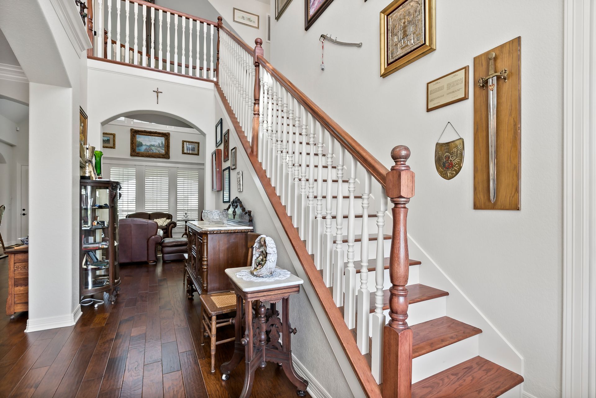 A wooden staircase in a house with a white railing
