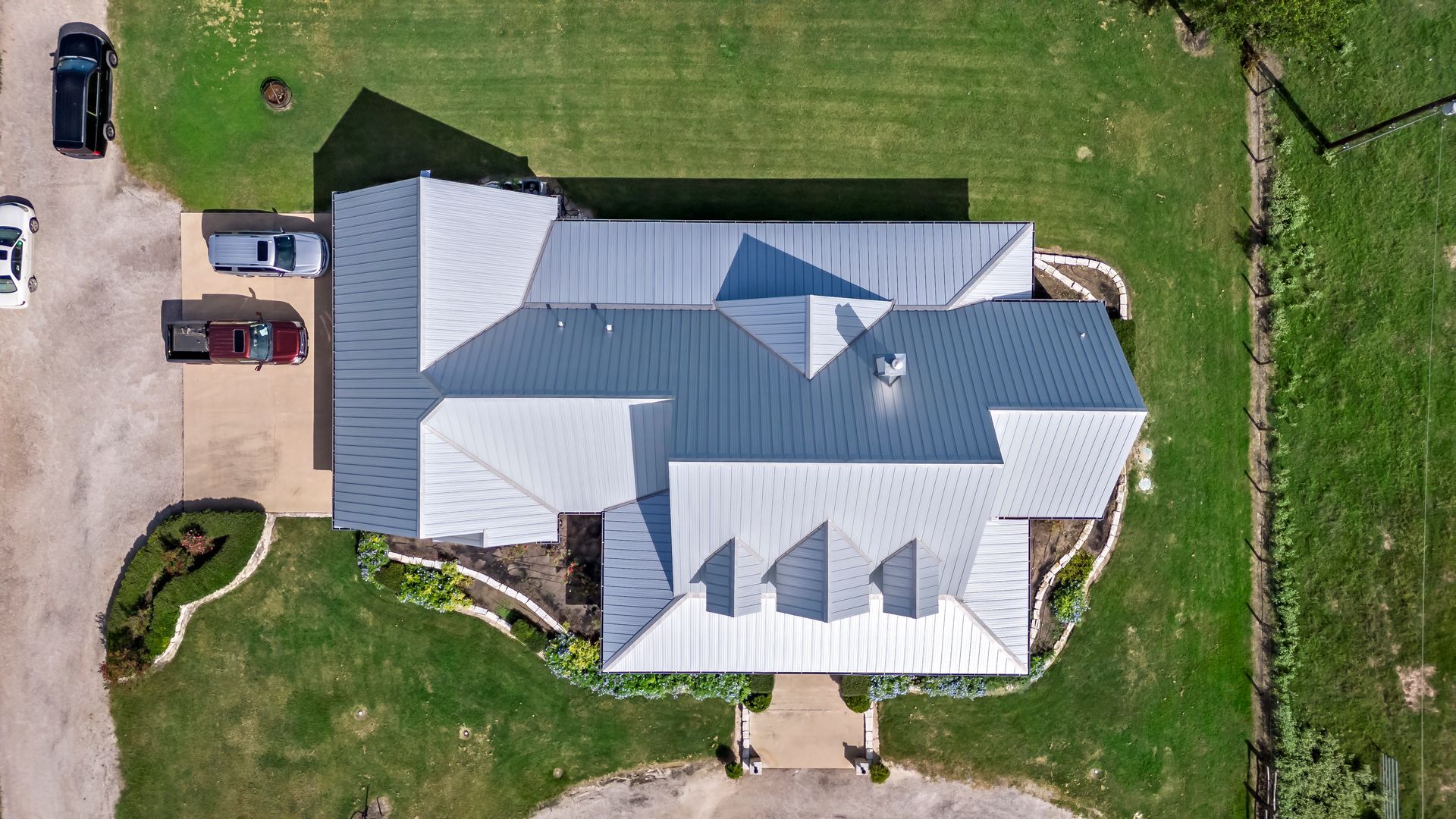 An aerial view of a house with a blue roof