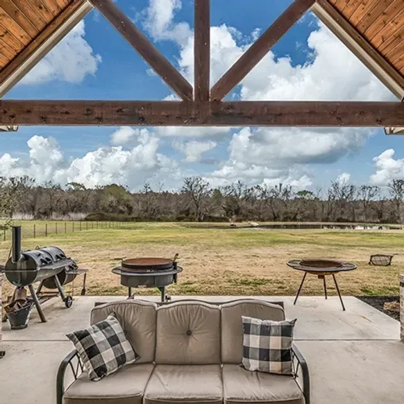 A patio with a couch and a fire pit