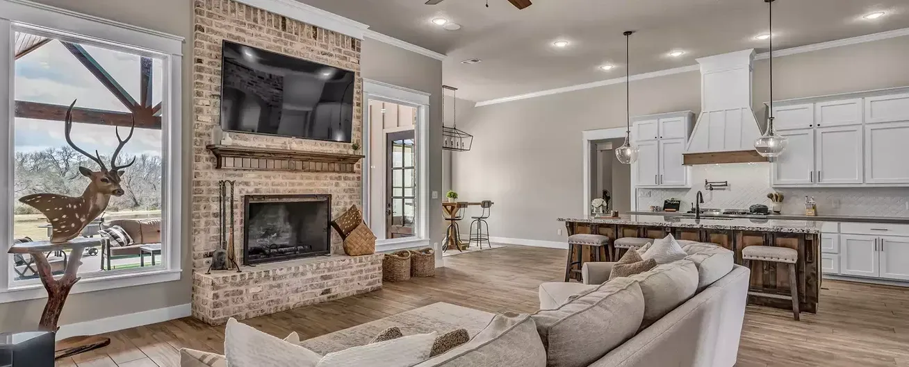 A living room with a couch , fireplace and television.