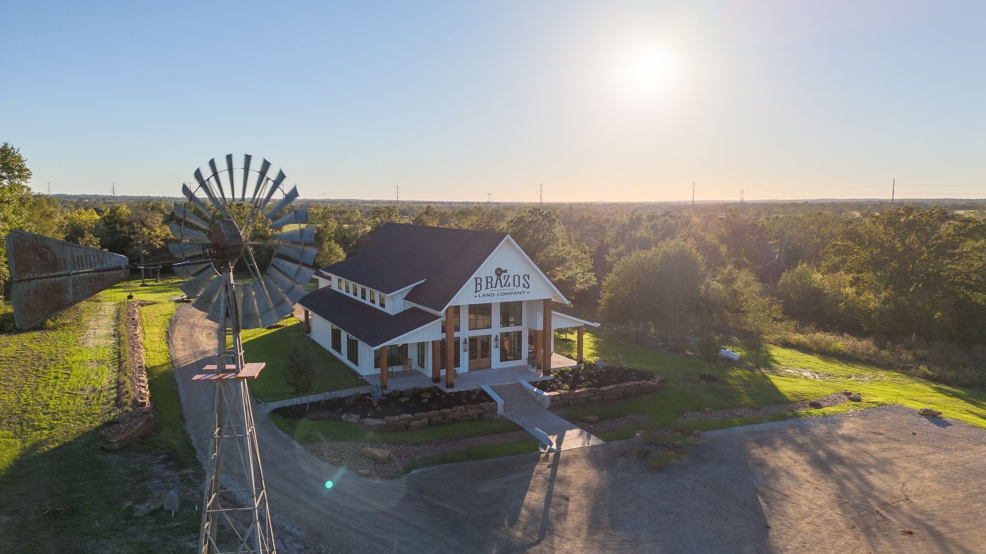 An aerial view of a house with a windmill in front of it.