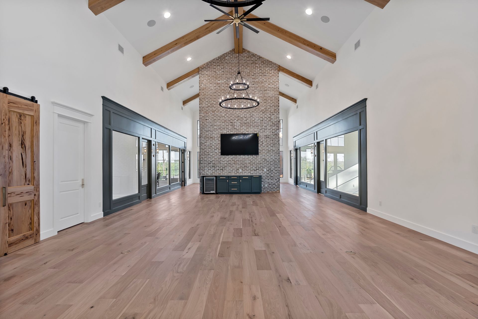 A large living room with hardwood floors and a ceiling fan.