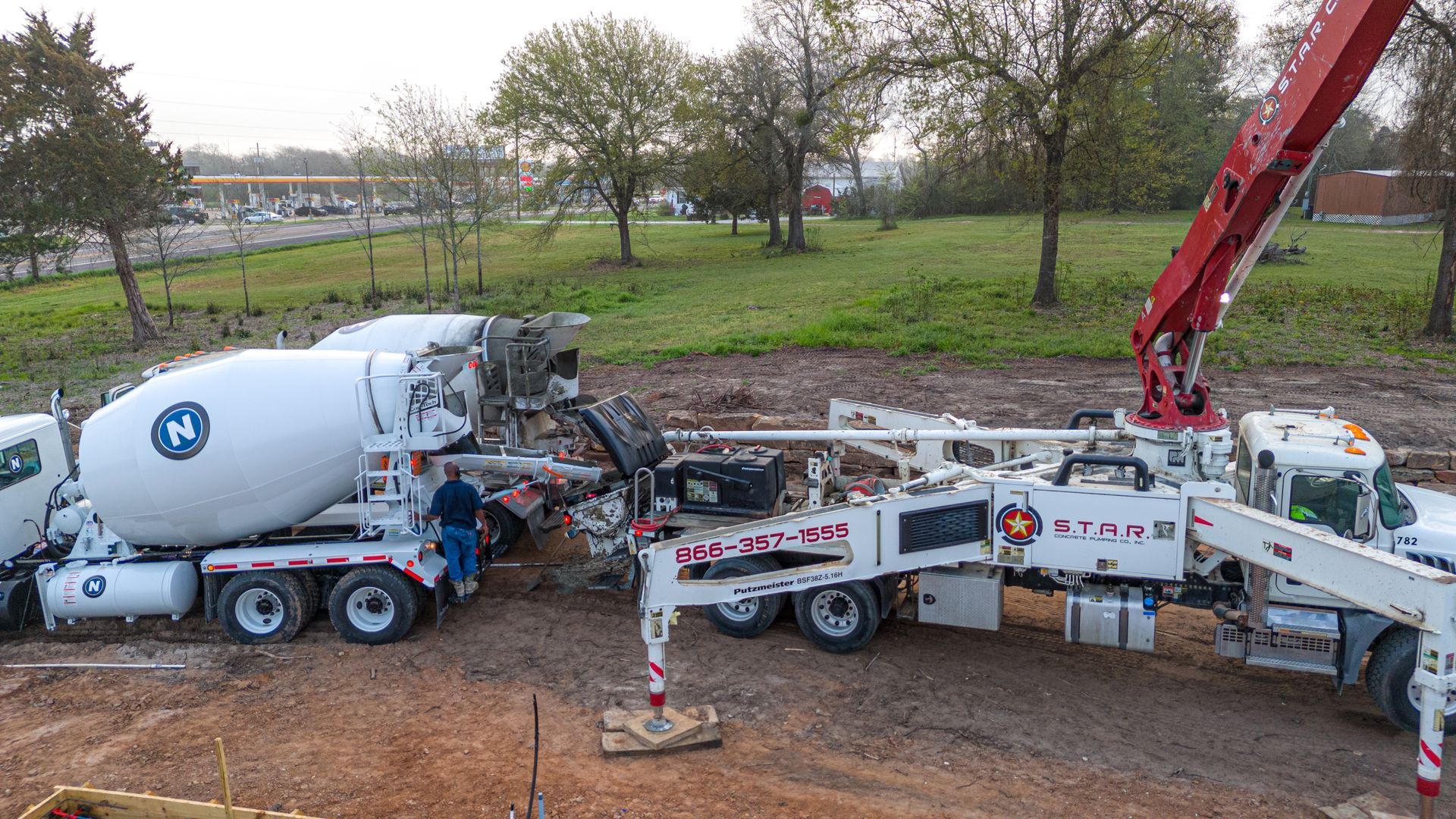 A concrete mixer and a concrete pump are working on a construction site.