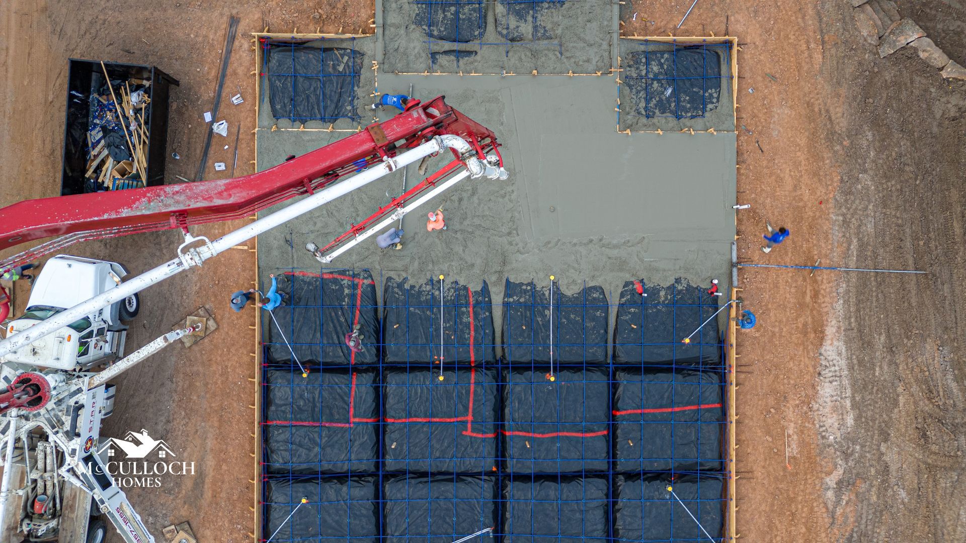 An aerial view of a concrete pump at a construction site.