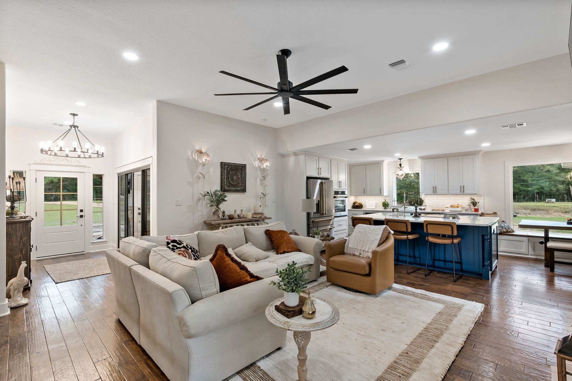 A living room filled with furniture and a ceiling fan.