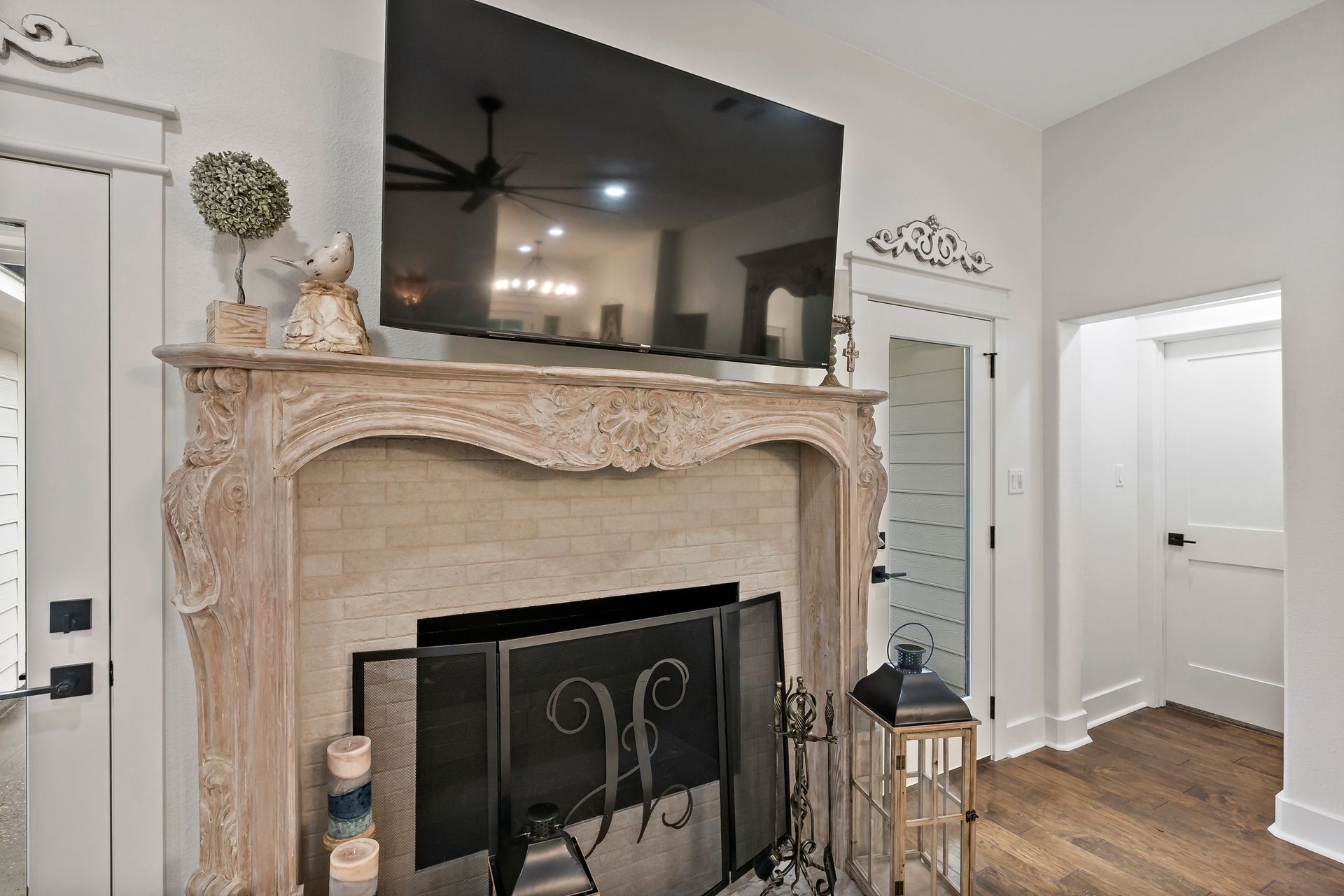 A living room with a fireplace and a flat screen tv above it.