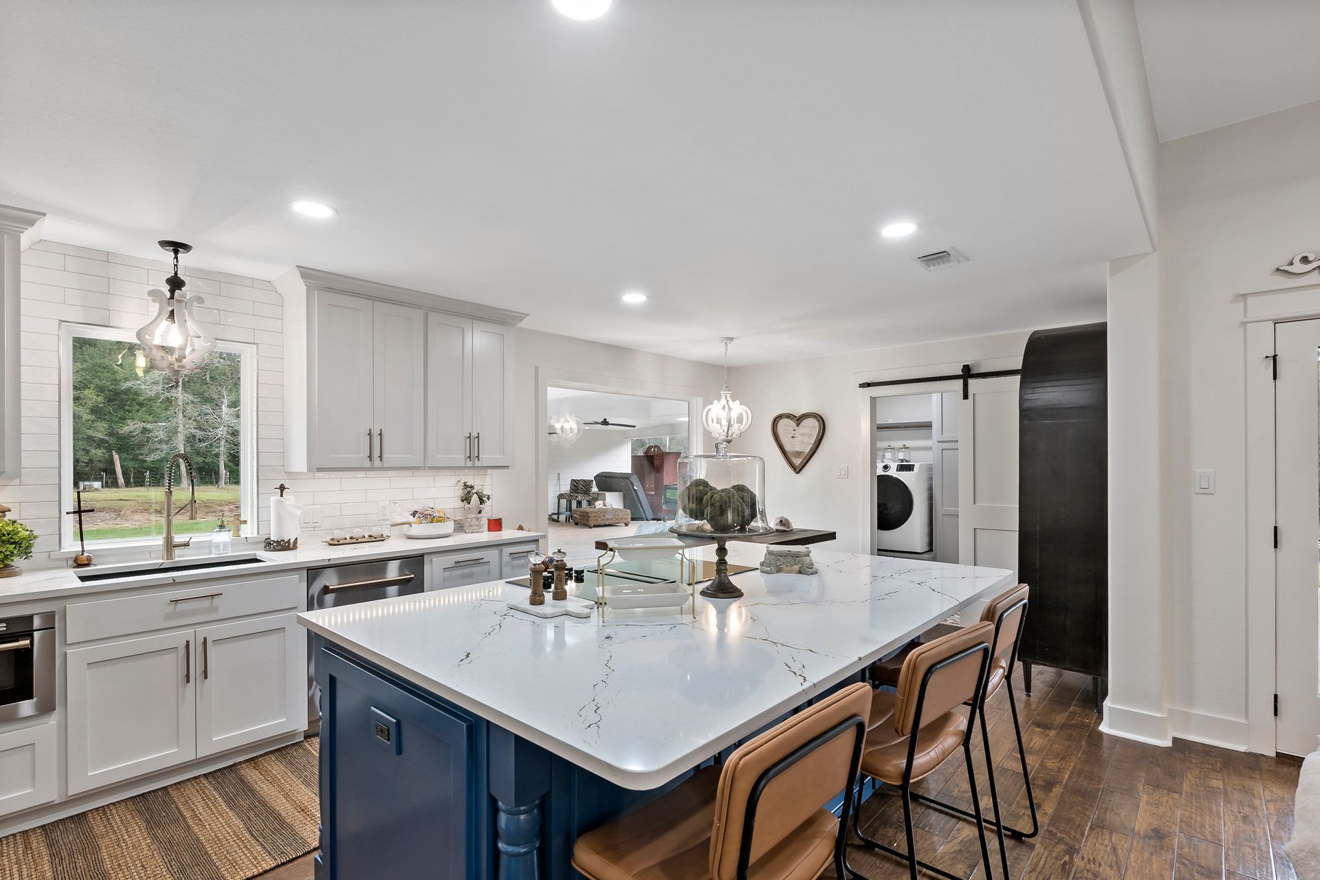A kitchen with a large island and white cabinets.