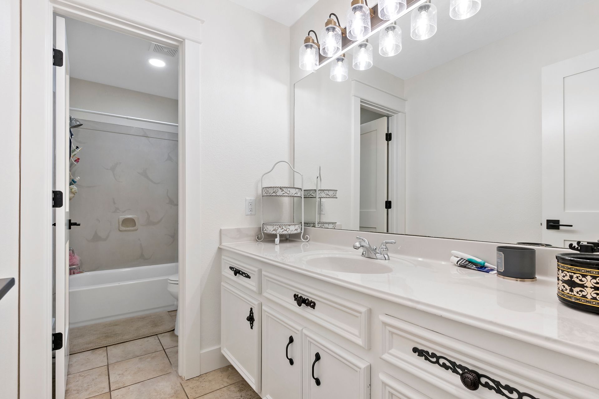 A bathroom with two sinks and a large mirror.