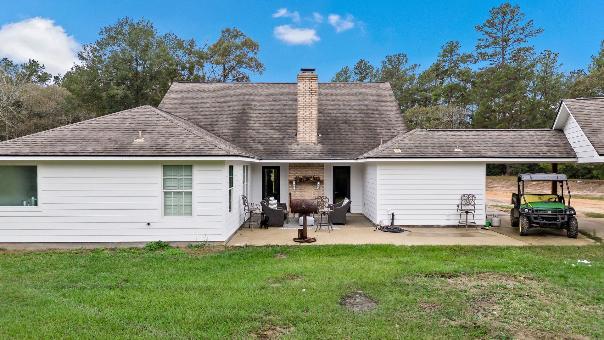 A white house with a golf cart parked in front of it.