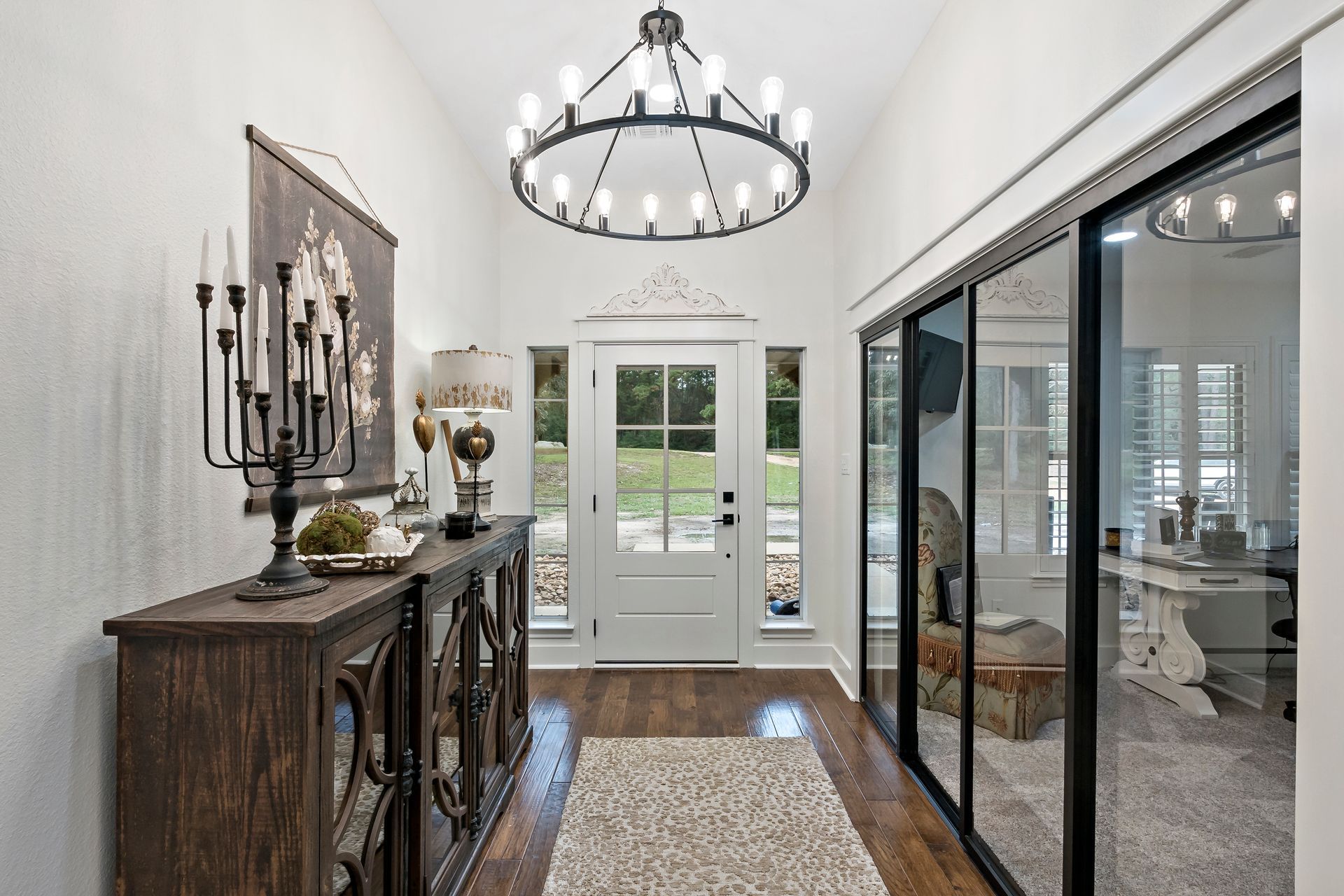 A hallway in a house with a chandelier hanging from the ceiling.
