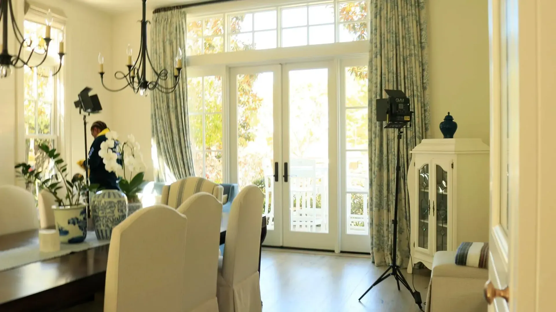 A dining room with a table and chairs and a sliding glass door.