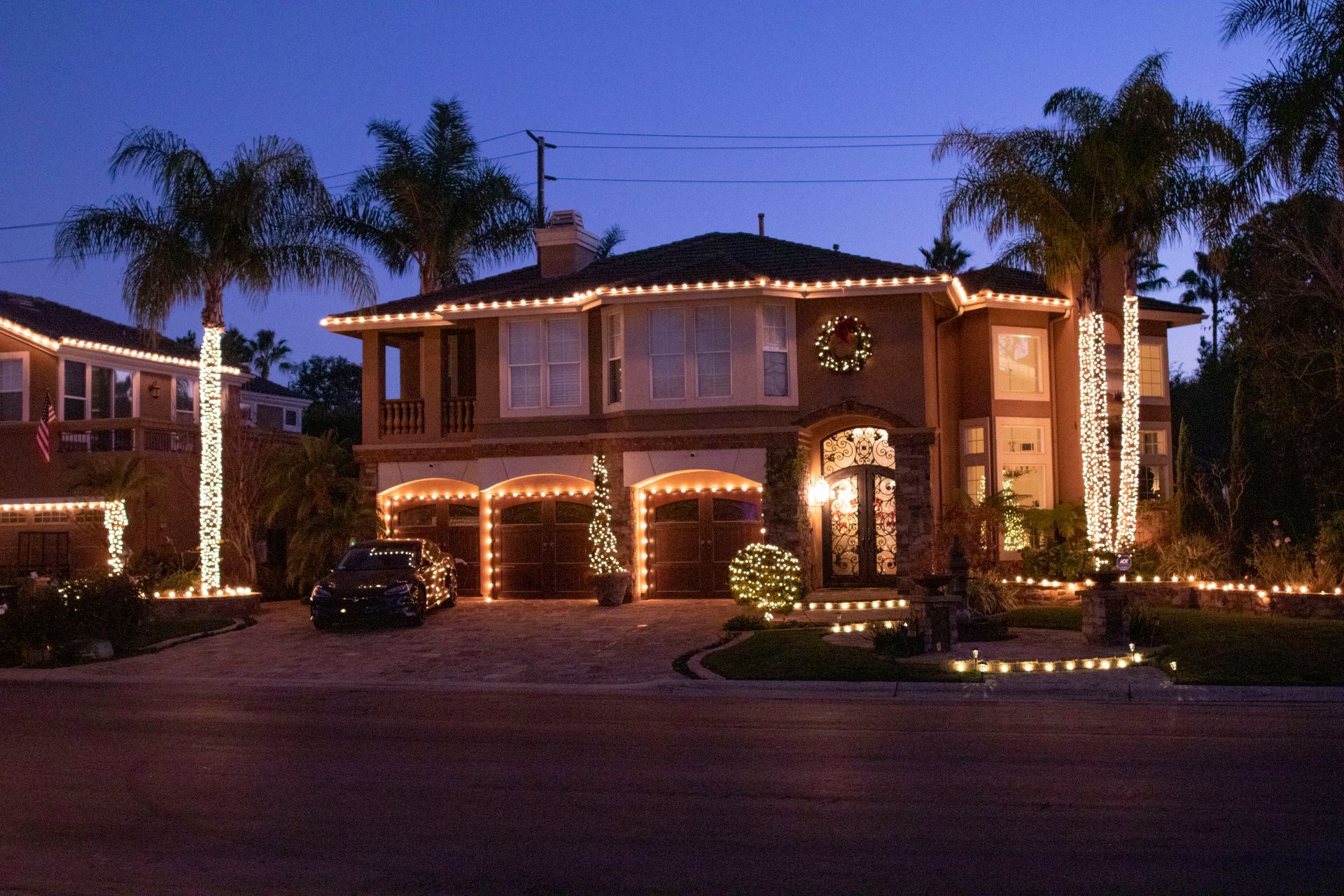 A man in a red shirt is cleaning a building with a hose