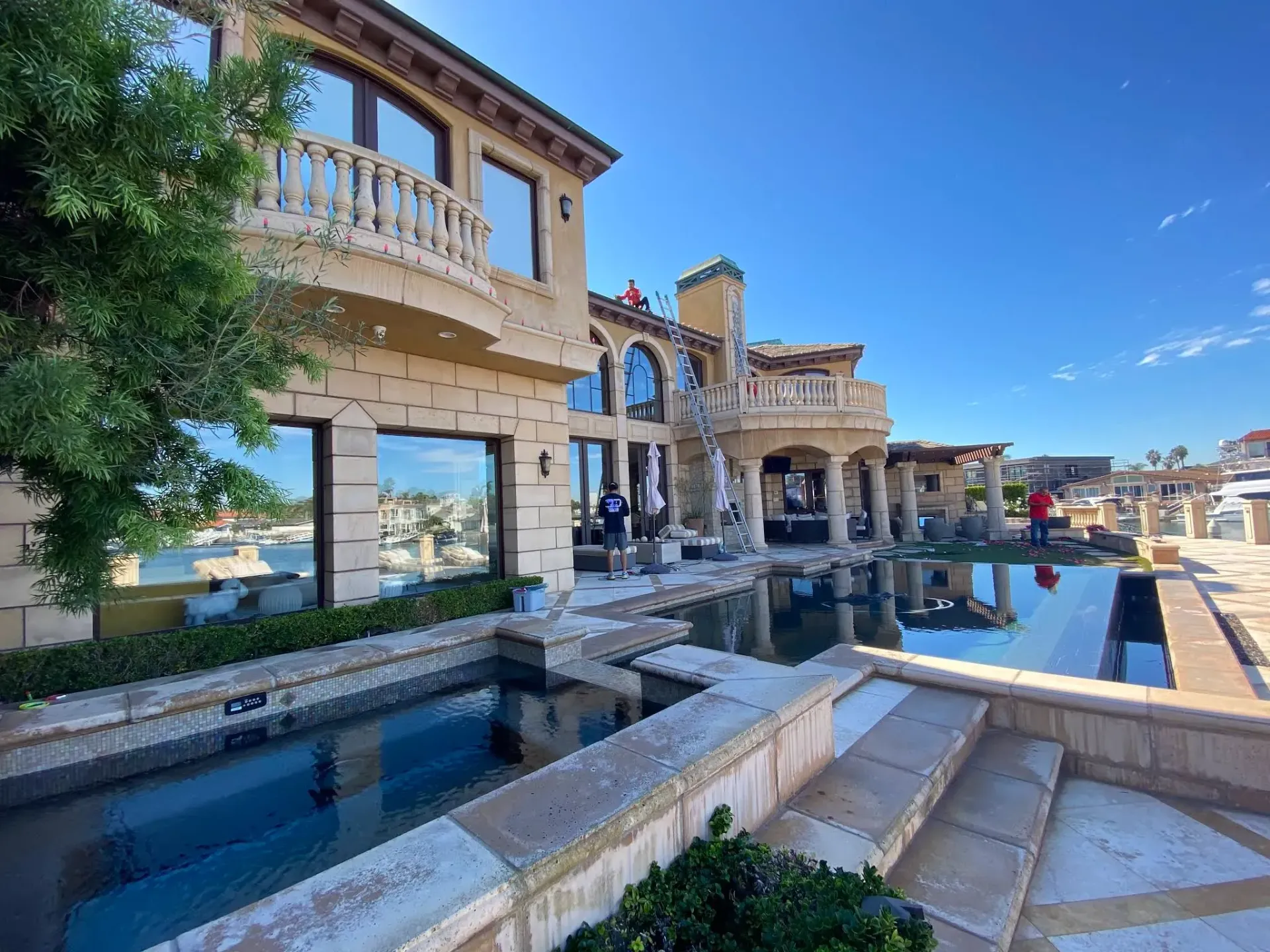 A large house with a swimming pool in front of it.