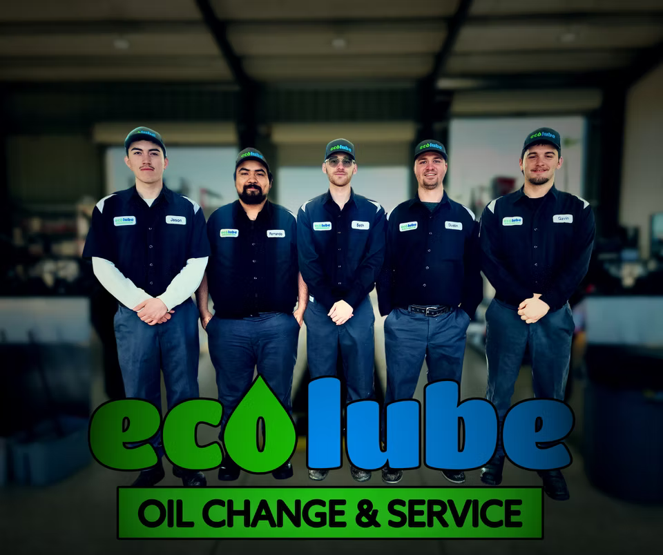 Five men in auto shop uniforms pose for a photo; ecOlube Oil Change logo at the bottom.