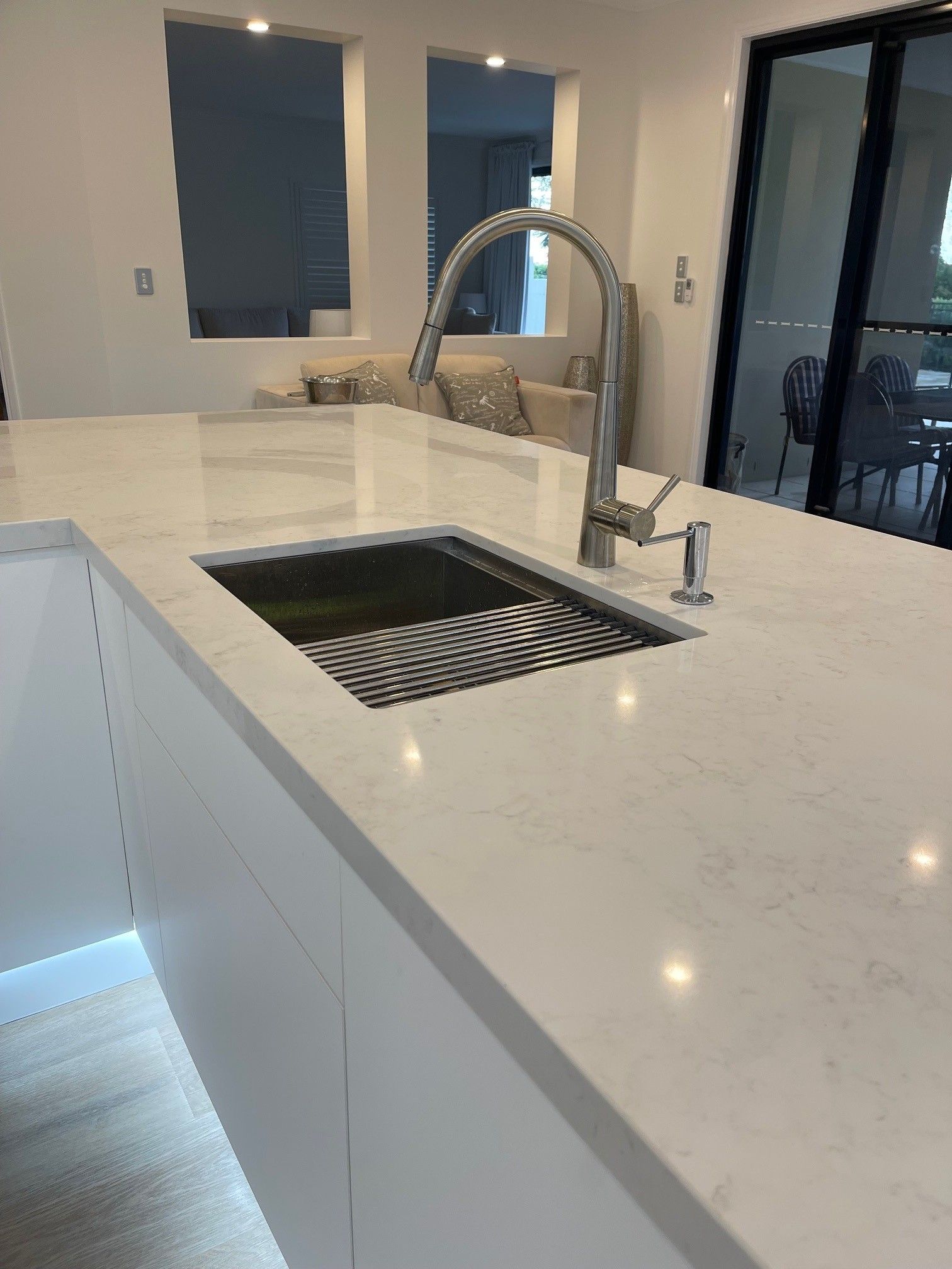 A kitchen with a sink and a faucet on the counter.