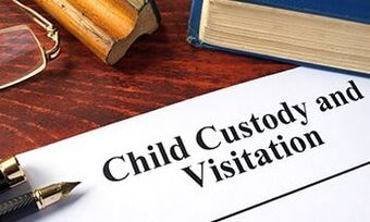 Child Custody and Visitation written on a paper and a book - trial attorney in Dubuque, IA