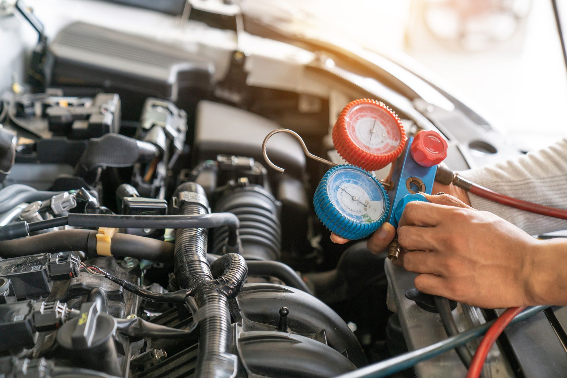 A person is working on the air conditioning system of a car.