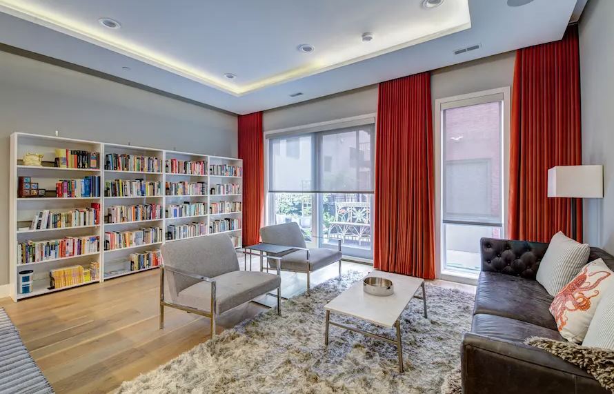 a living room with a couch , chairs , coffee table and bookshelves Love is Blinds Colorado  serivices.