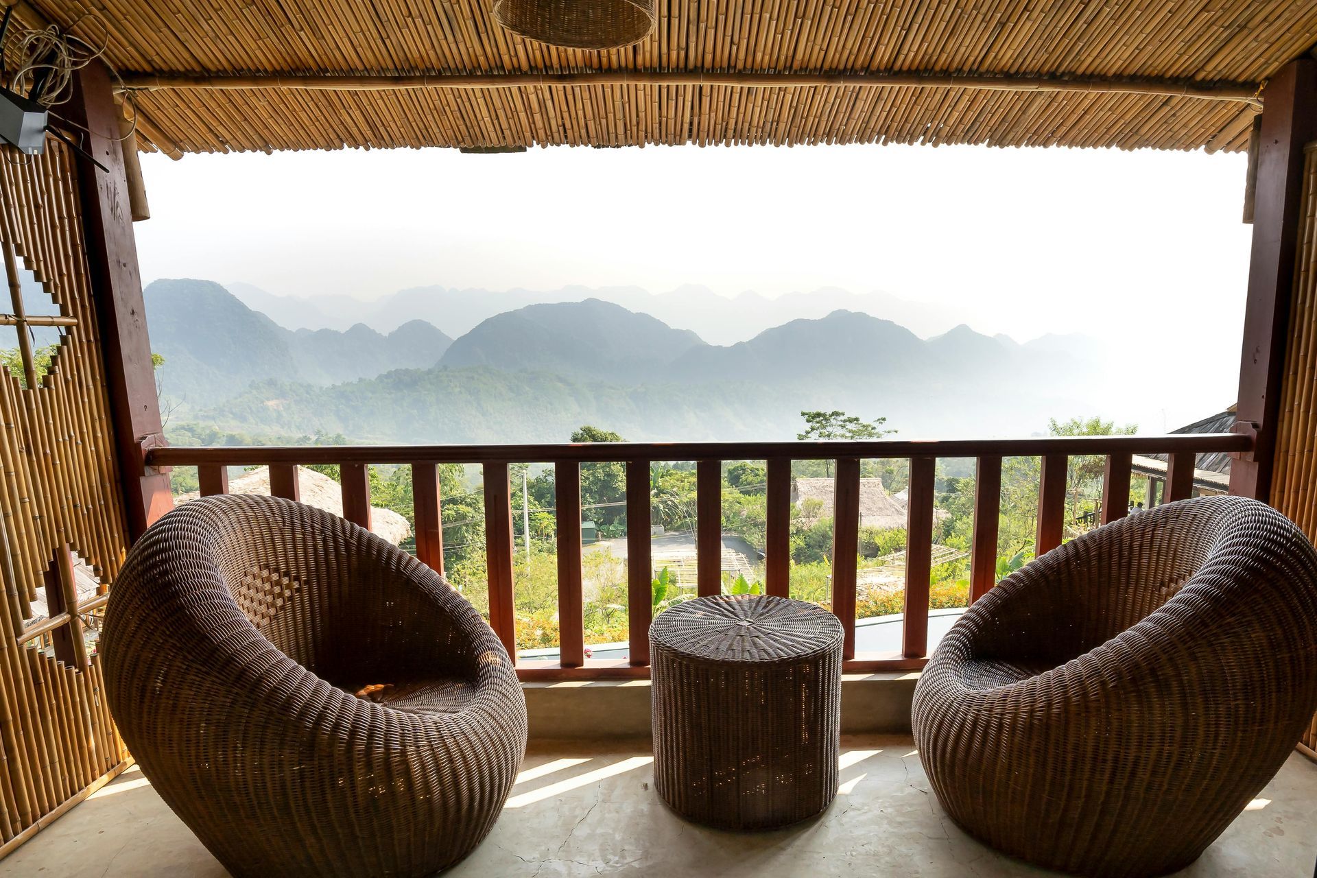 a deck with chairs overlooking mountains