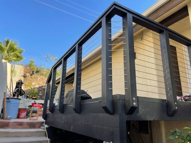 A house with a black railing and stairs