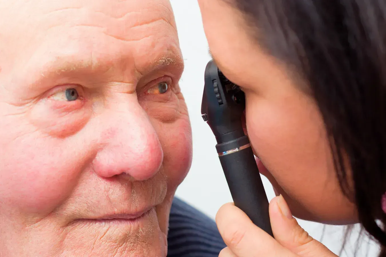 Eye doctor performing exam to diagnose cataracts causing blurry vision