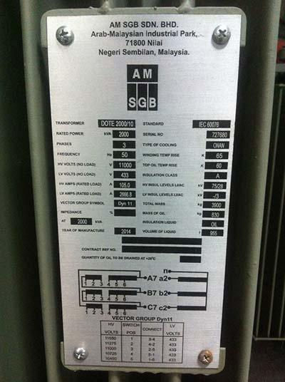 Silver transformer label with technical specifications, featuring manufacturer's name and industrial park location.