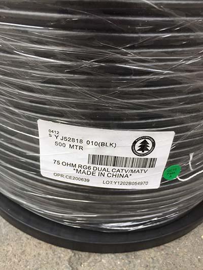 Coaxial cable spool with a label indicating it's 75 OHM, dual CATV/MATV, made in China.