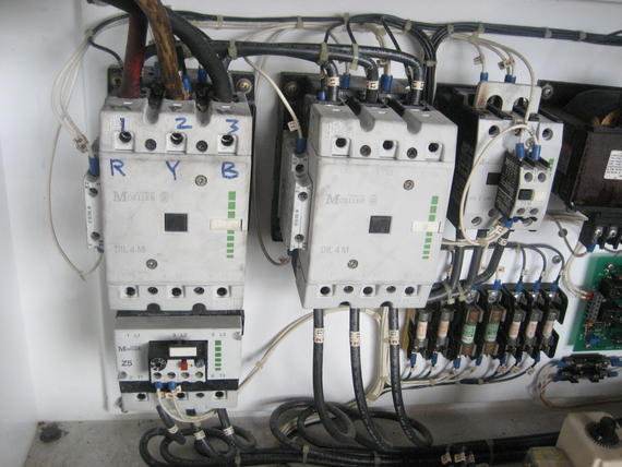 Electrical control panel with wires and circuit breakers. 