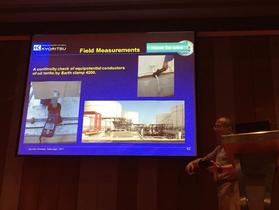 Man presenting field measurement data on a screen, with photos of electrical work and equipment.