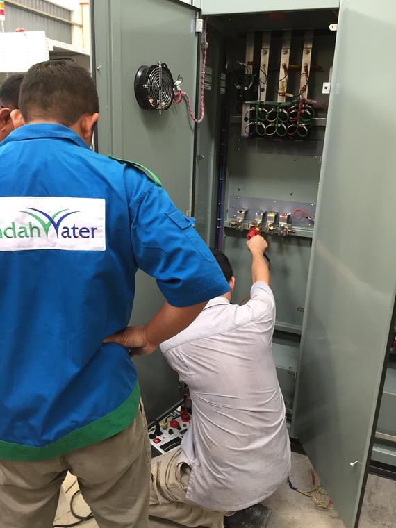 Two men in work uniforms, one with 