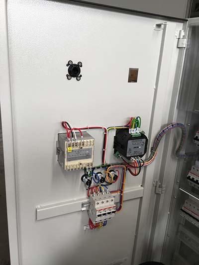 Electrical control panel with various components, wiring, and a circuit breaker.