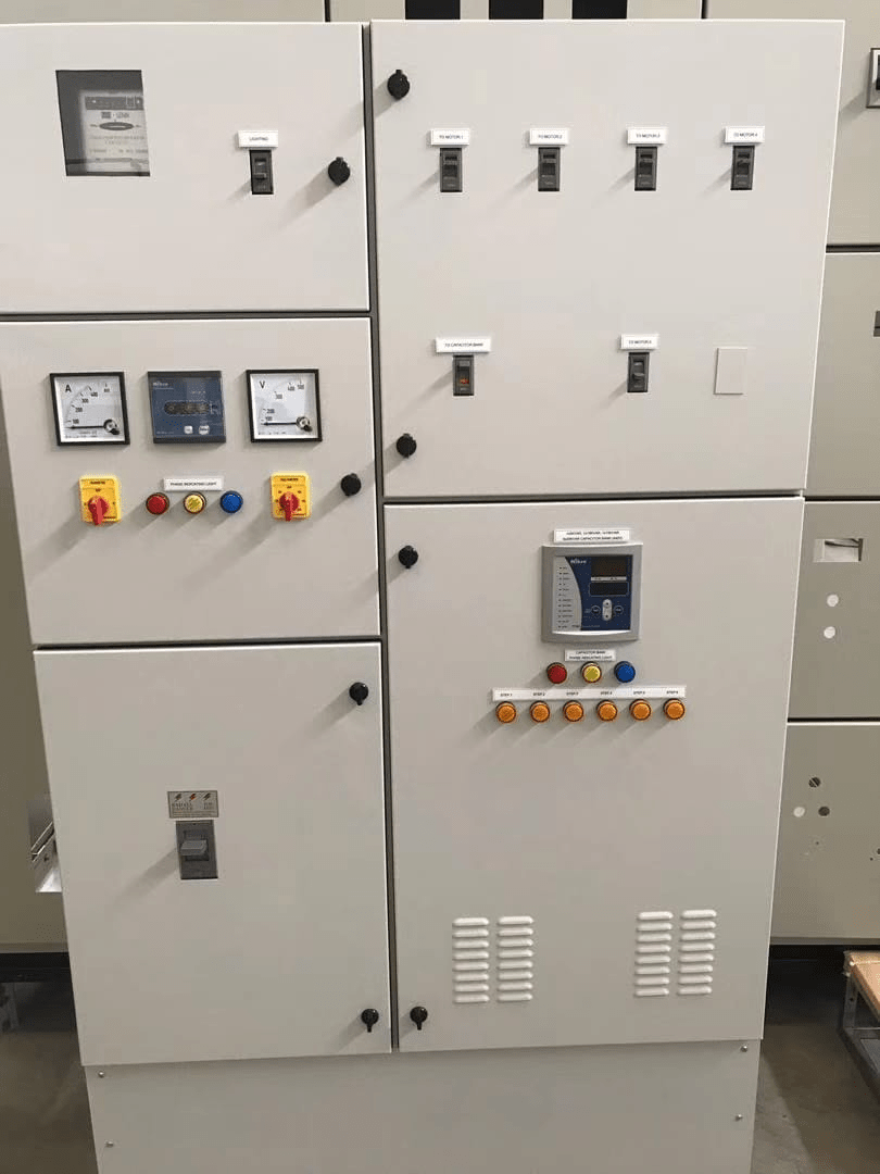 Electrical control panel with switches, meters, and indicator lights.