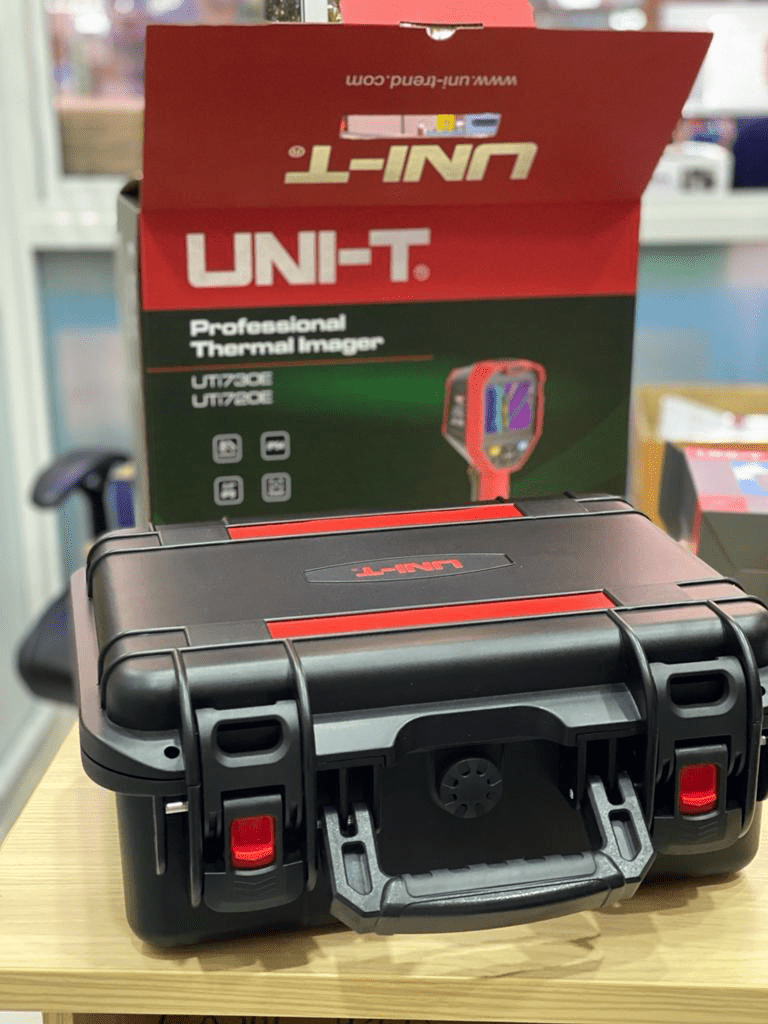 A black hard case with a red-accented lid containing a UNI-T Professional Thermal Imager box.