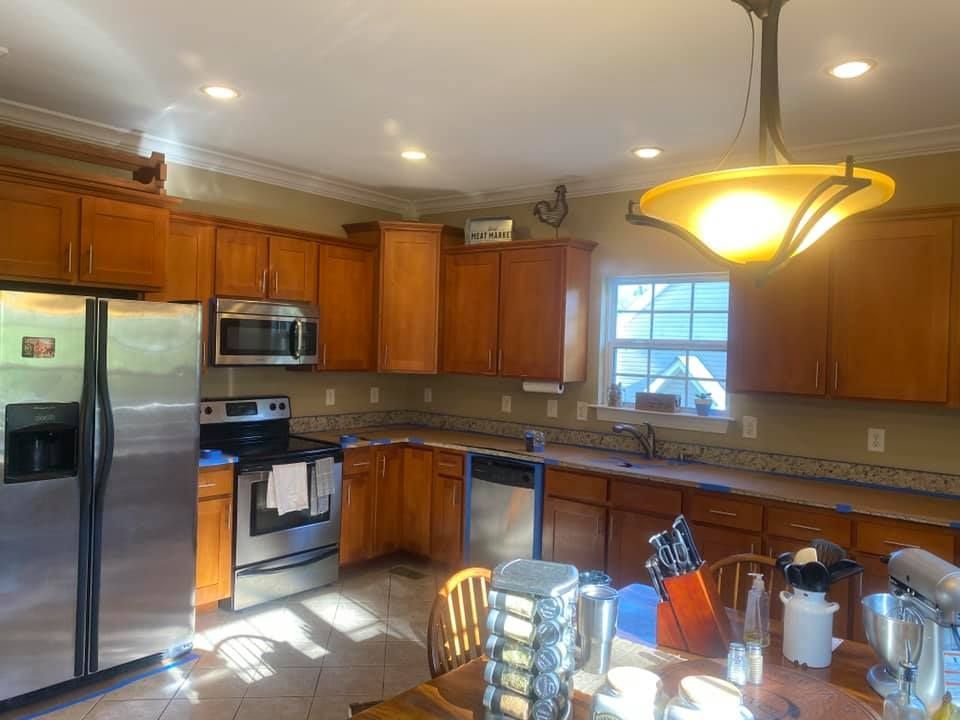 A kitchen with stainless steel appliances and wooden cabinets.