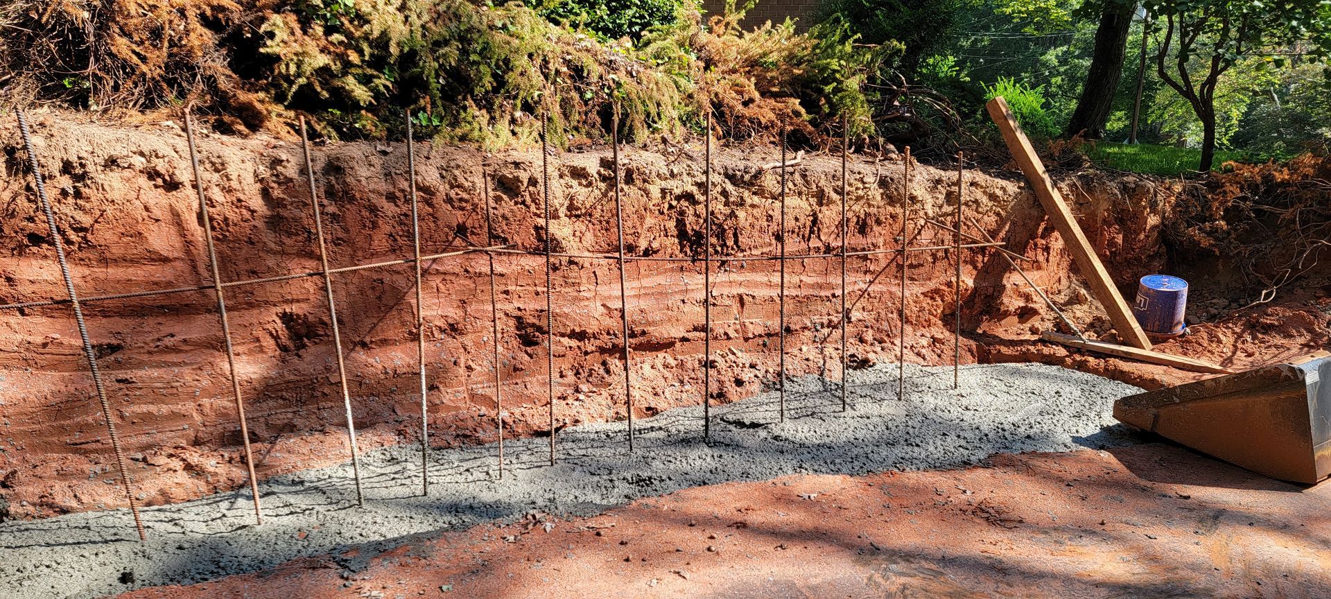 A shovel is sitting on the ground next to a pile of dirt.