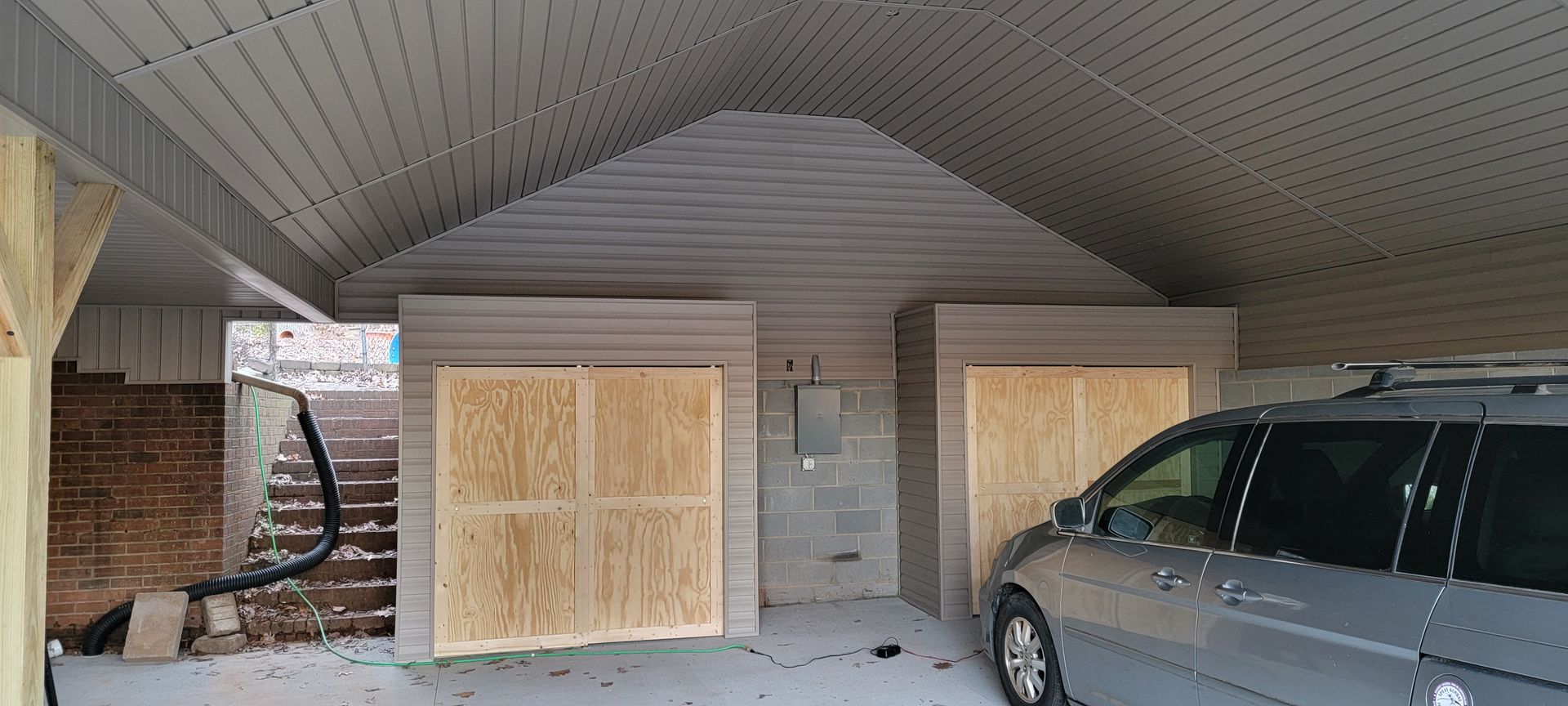 A van is parked in a garage under construction.