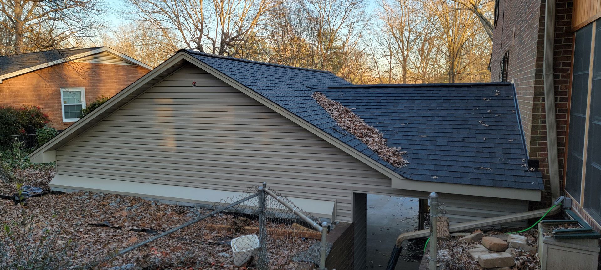 A house with a blue roof is being remodeled.