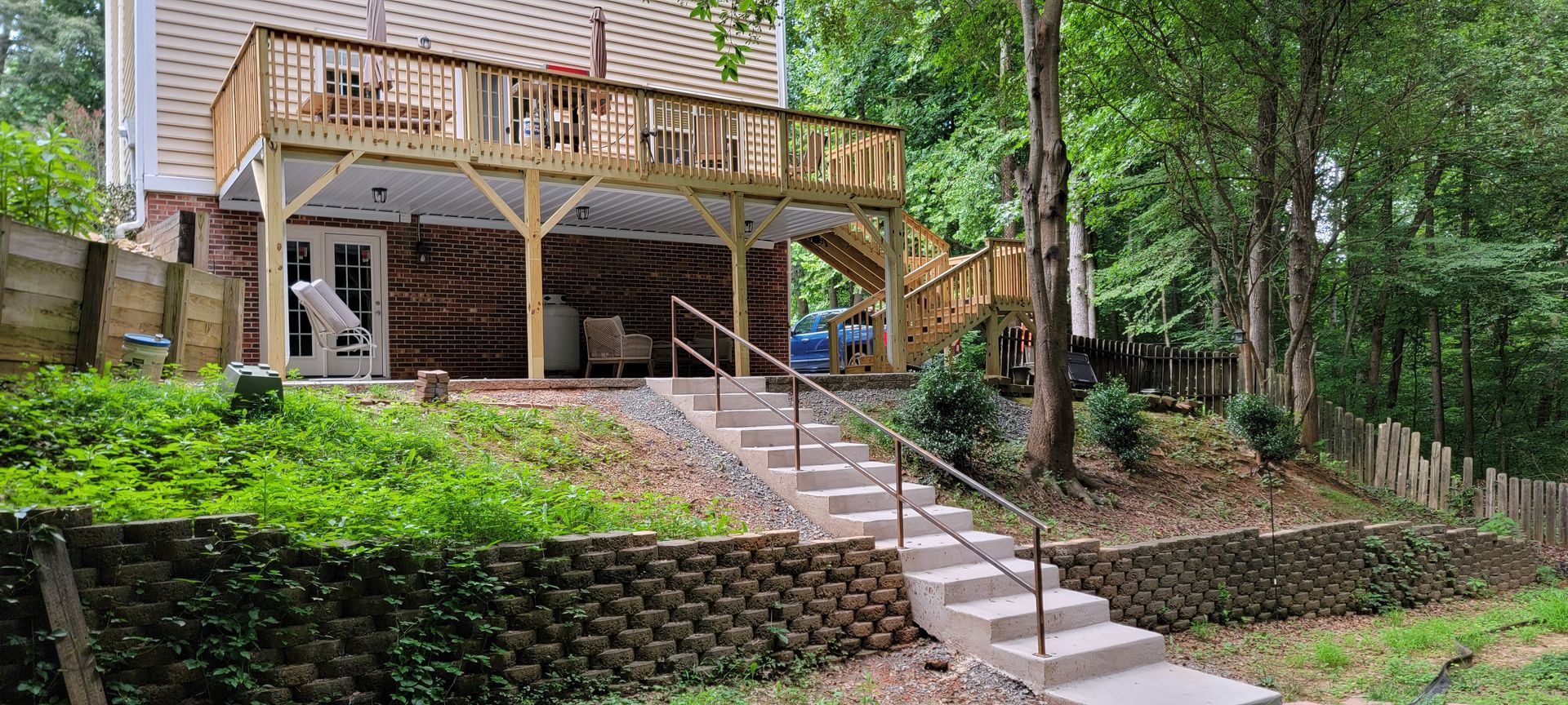 A house with a large deck and stairs leading to it.
