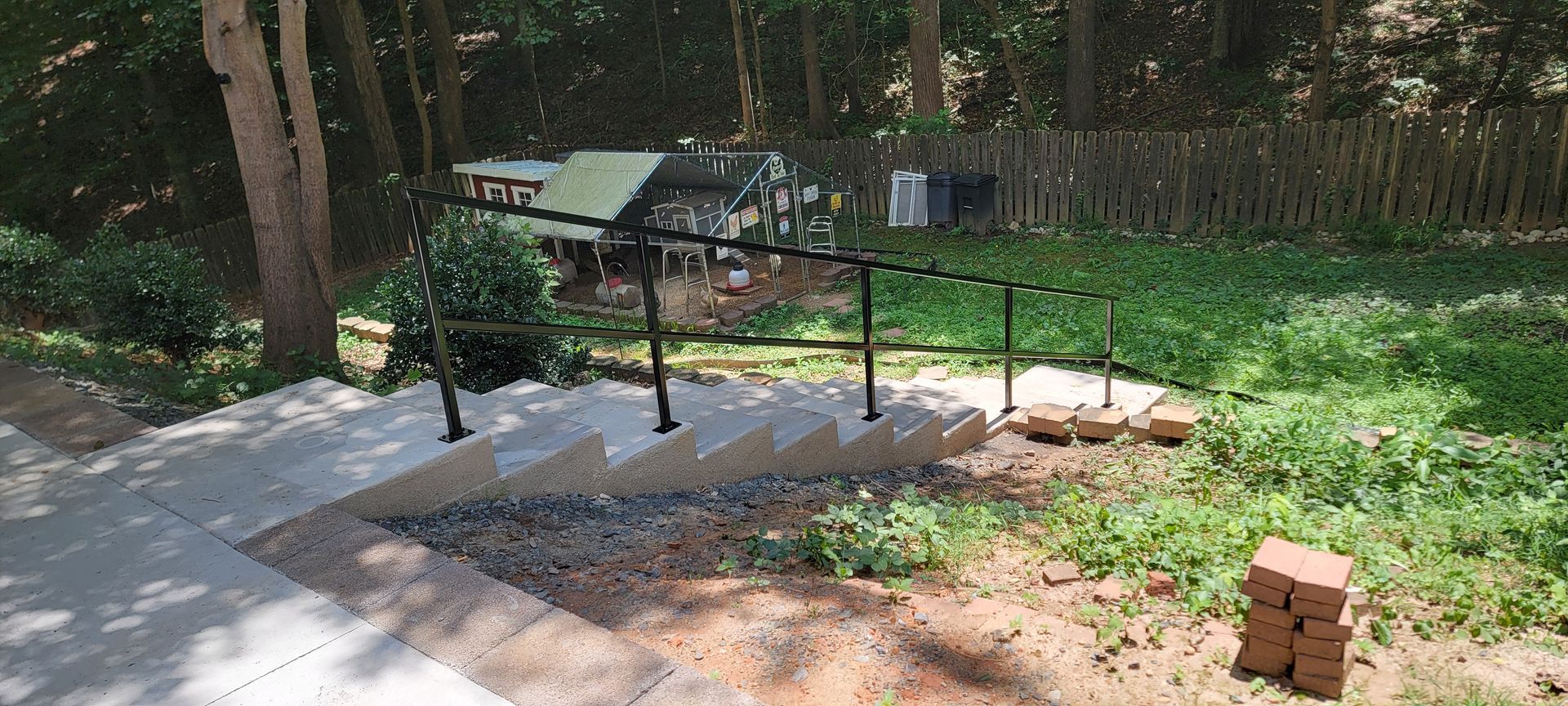 A set of stairs leading up to a house in the woods.