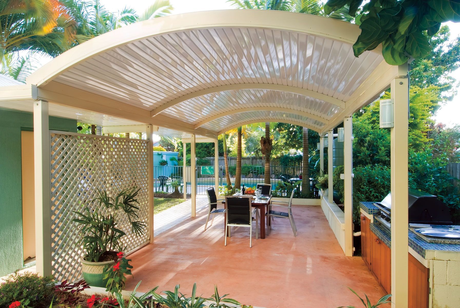 A patio with a table and chairs under a canopy