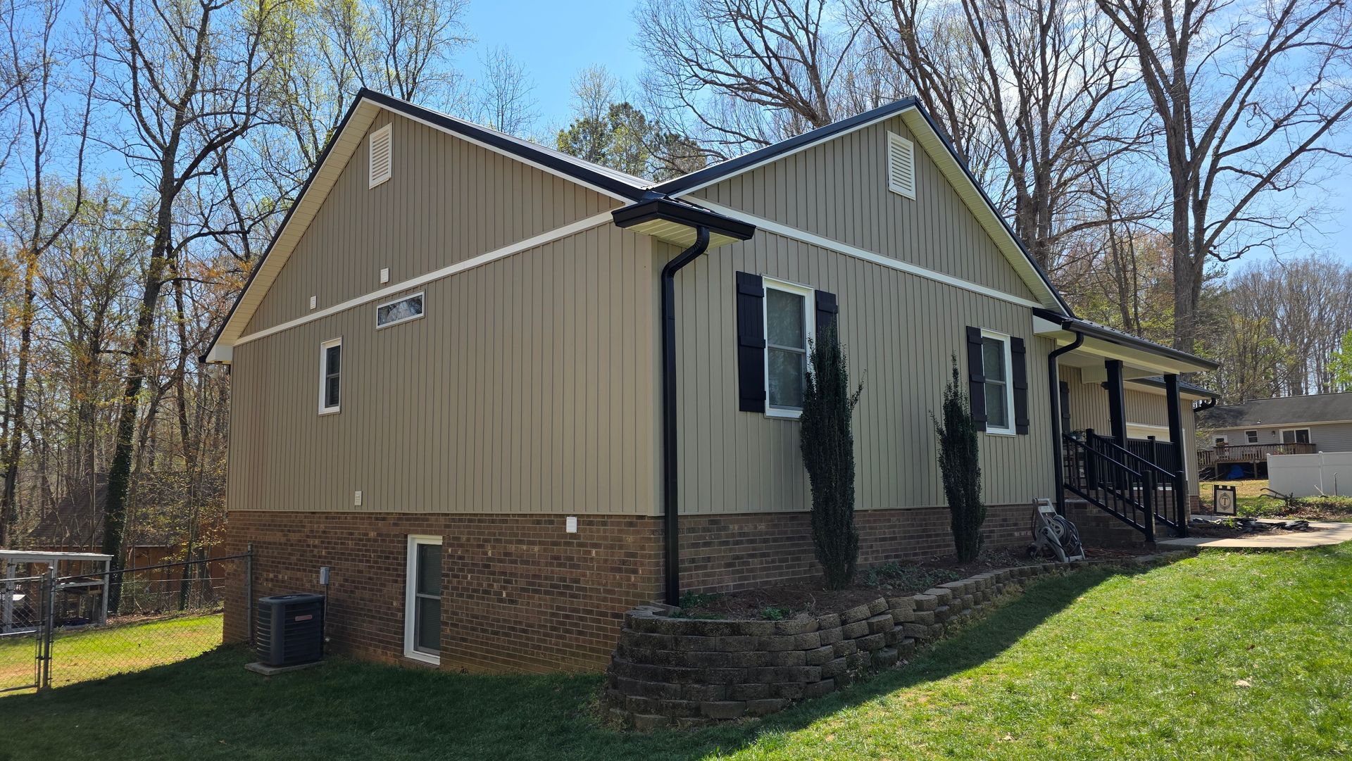 Entryway into sunroom with large windows and soft gray walls