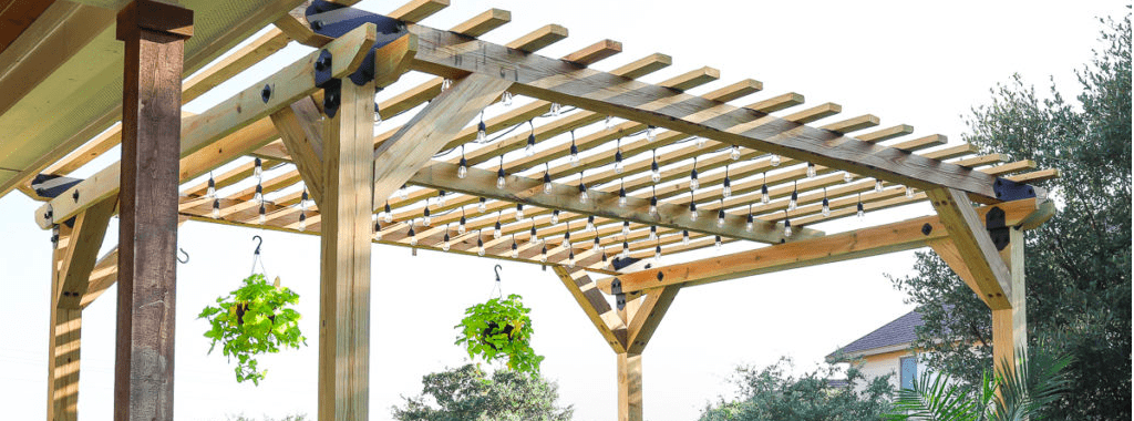 A wooden pergola with potted plants hanging from it