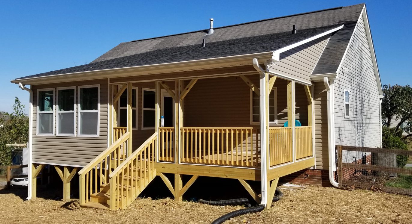 A small house with a porch and stairs