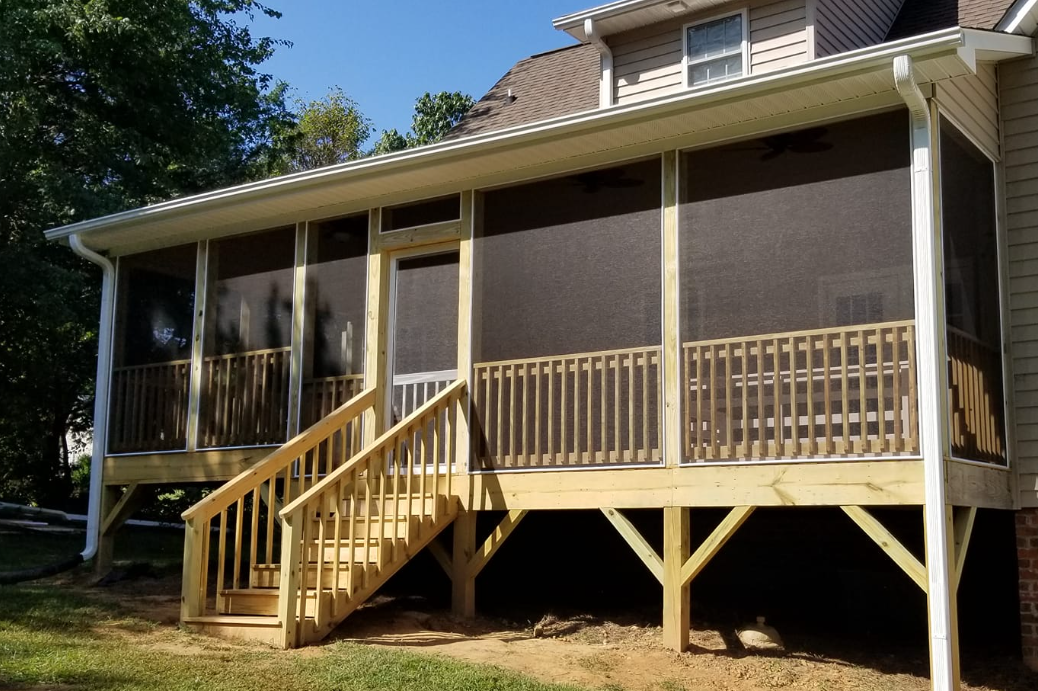 A house with a screened in porch and stairs